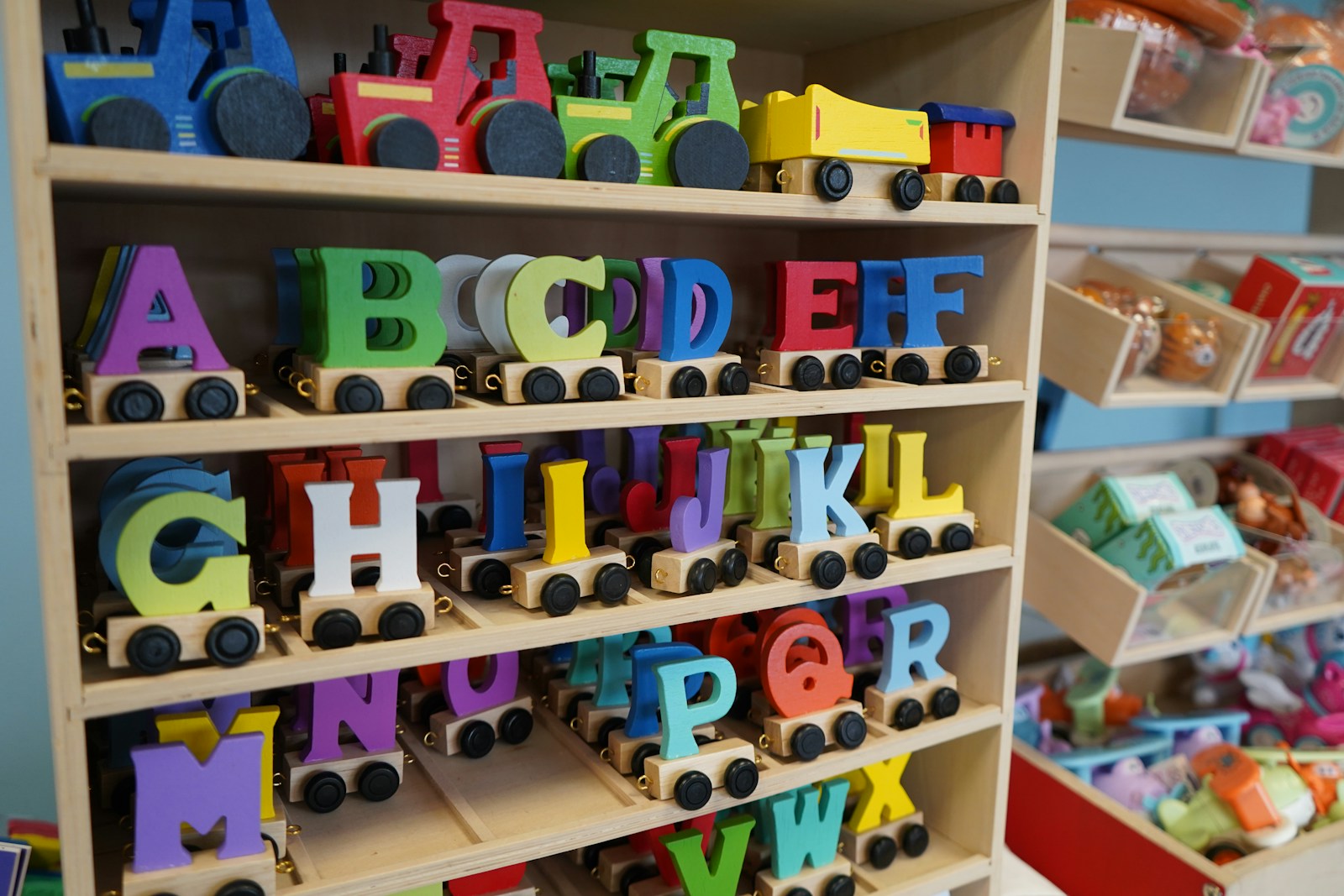 Colorful wooden alphabet letters on toy train wheels